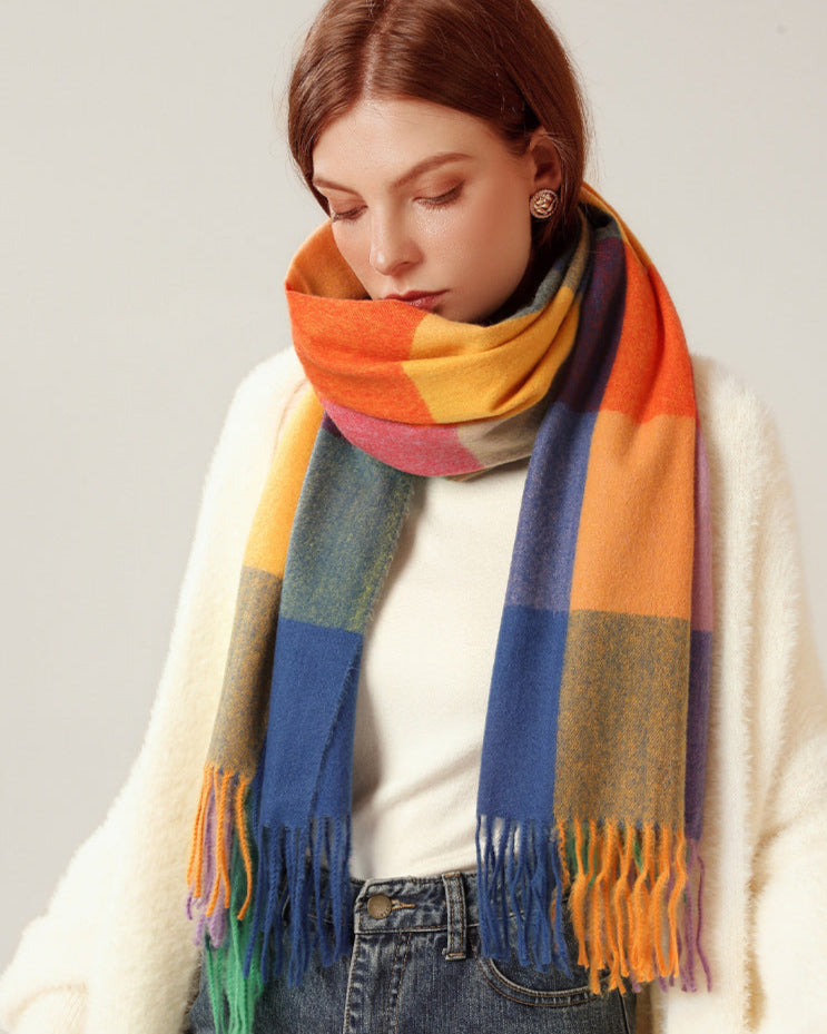Woman wearing a colorful striped scarf against a plain background