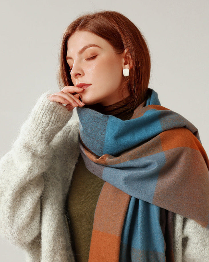 Woman wearing a colorful scarf with a neutral background