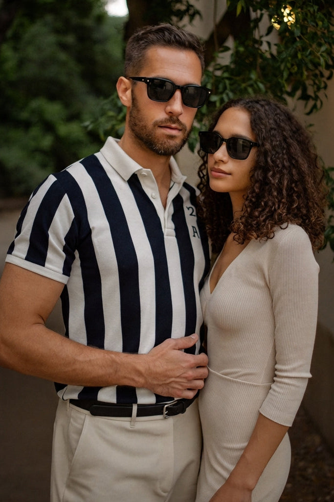 Man and woman standing close together outdoors with sunglasses on