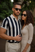 Man and woman standing close together outdoors with sunglasses on