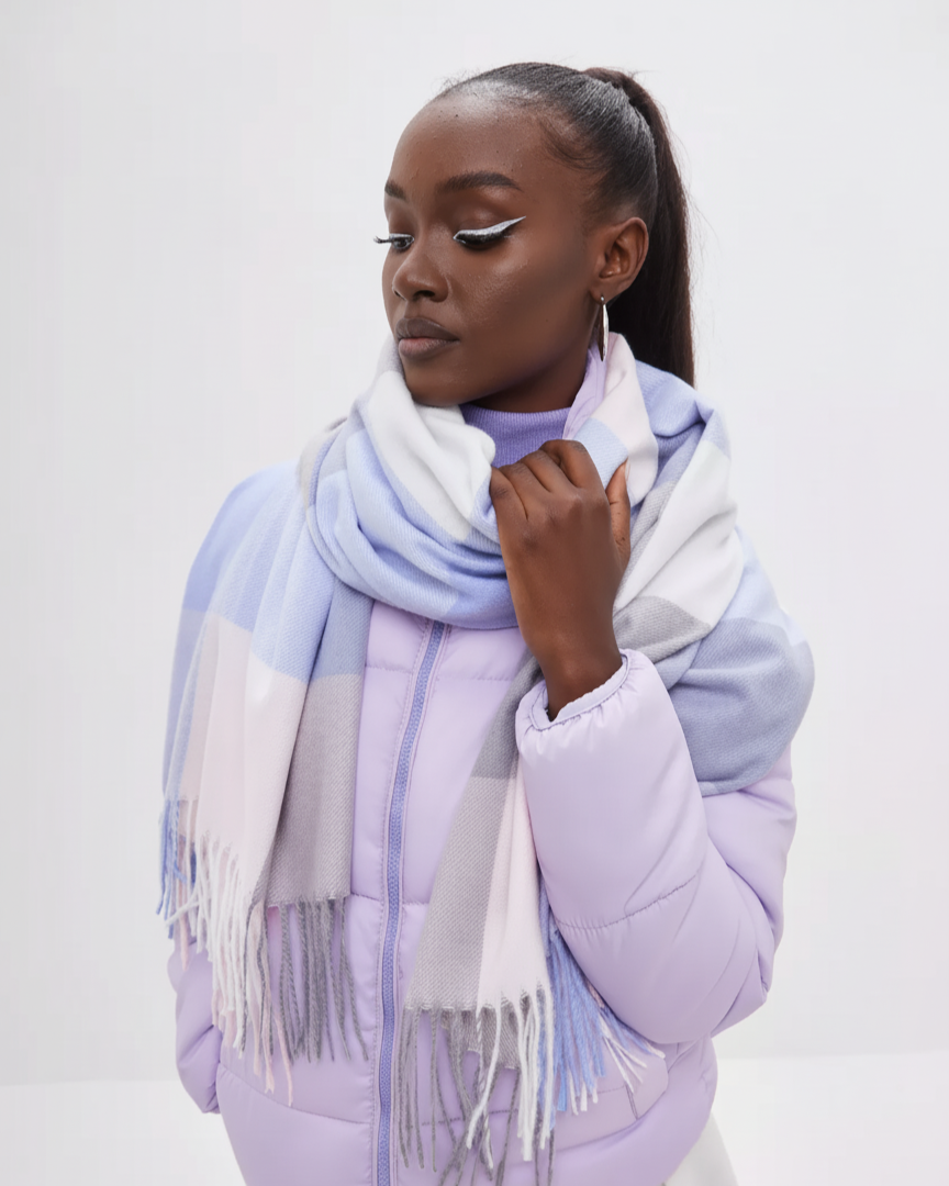 Woman wearing a light purple coat and scarf with a white background