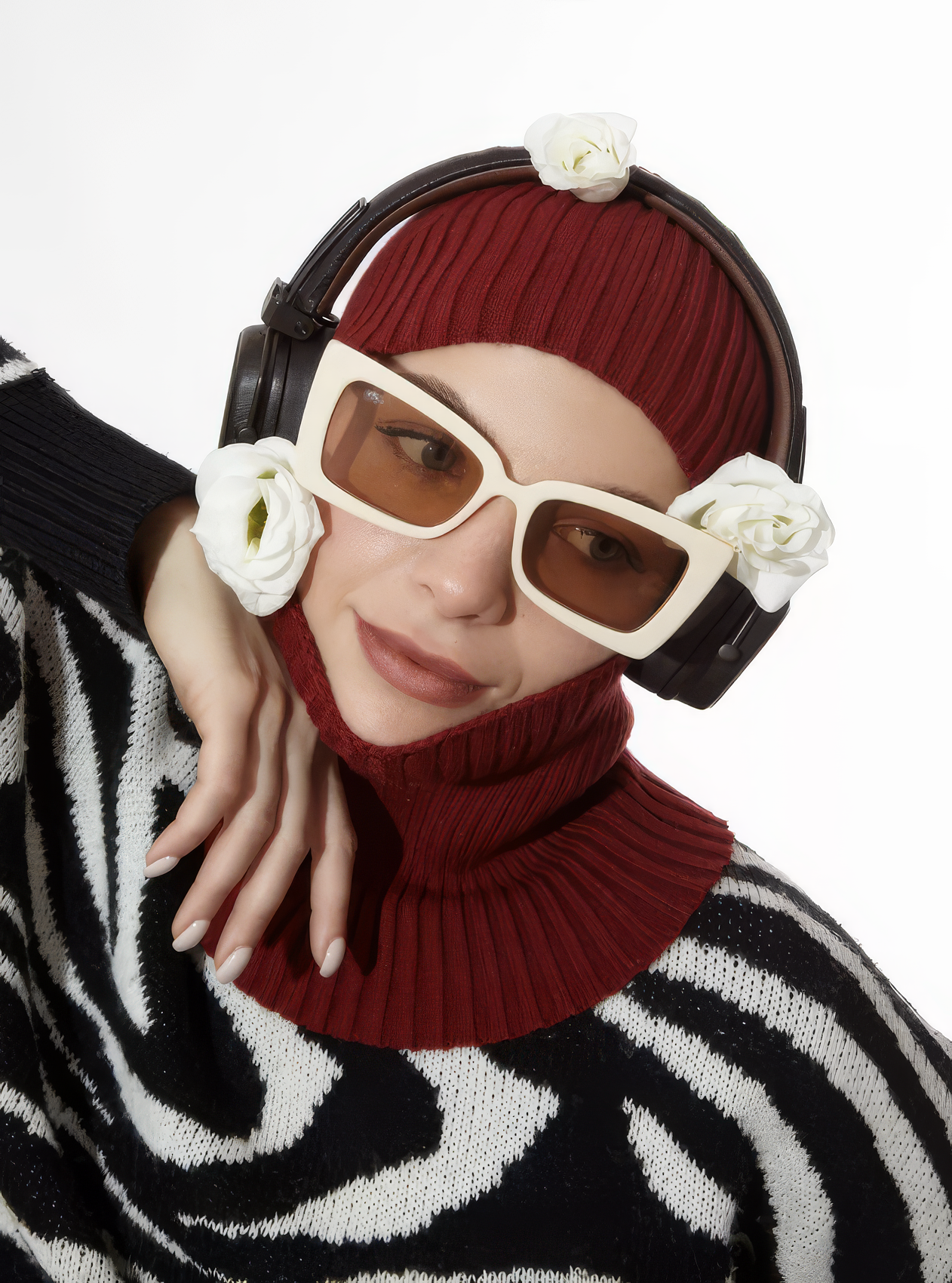 Person wearing a zebra-patterned sweater, red turtleneck, and large sunglasses with floral decorations.