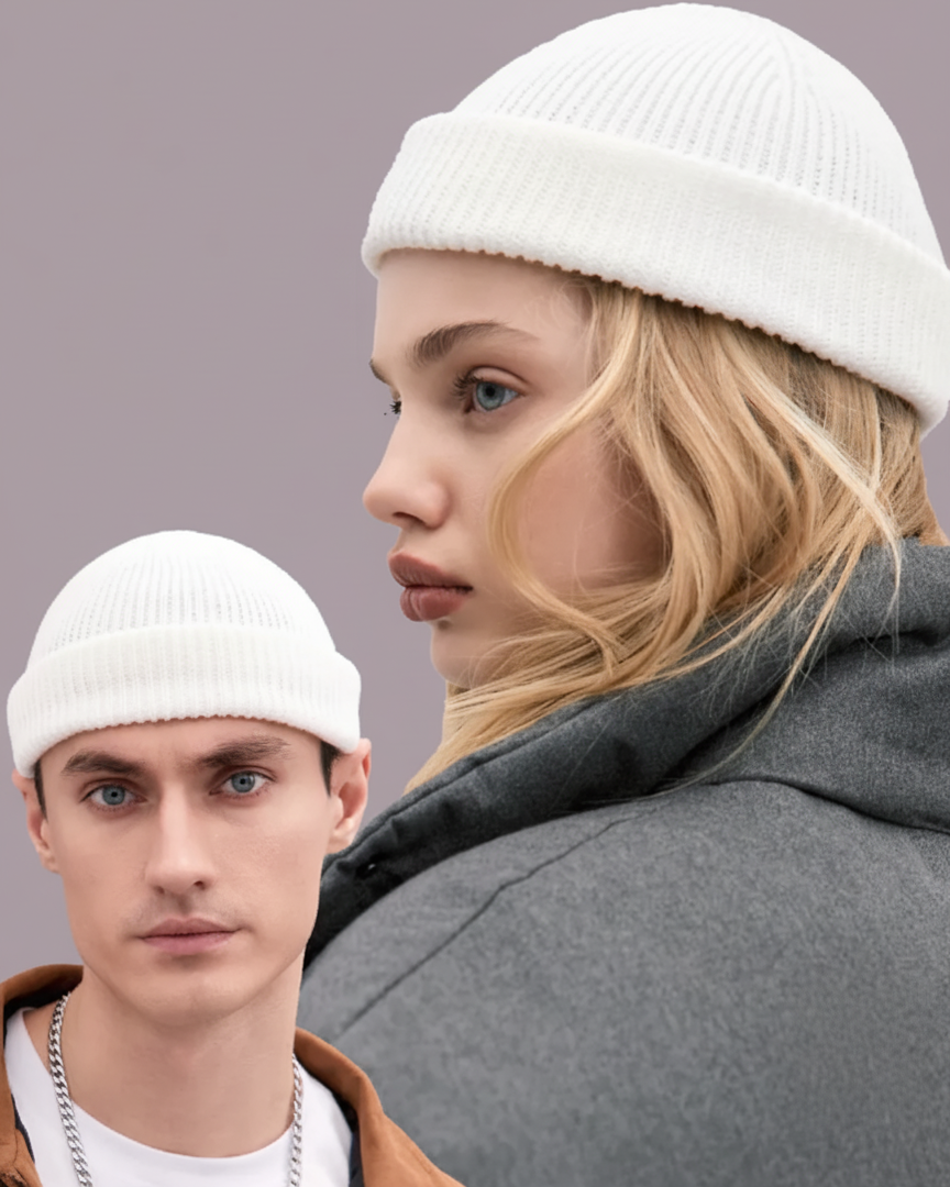 Two people wearing white beanies with a neutral background