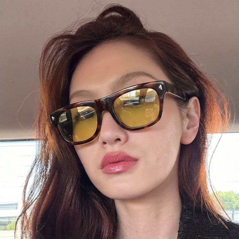 Person wearing sunglasses with a blurred background