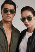 Two people wearing sunglasses against a plain background